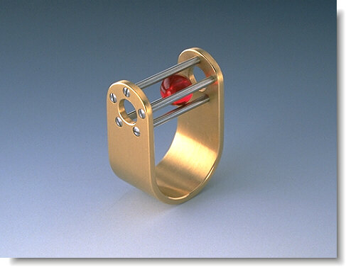 Ruby Ball Ring A gold ring with ruby ball enclosed.