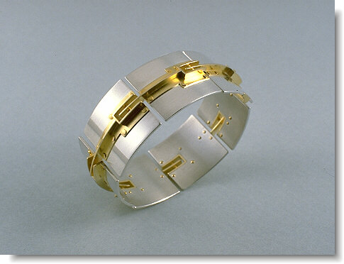 Silver and Gold Bracelet with Rivets A silver and gold bracelet with rivets.