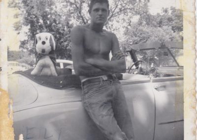 Ernie standing with his first convertible (close view).