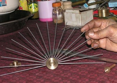 Adding spokes to the wheel hub.
