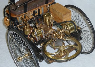 Close-up of engine and flywheel on the Benz.