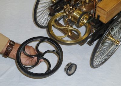 The flywheel cast next to the finished model.