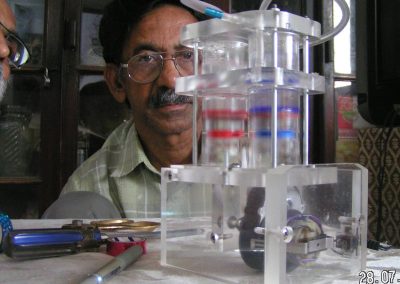 Iqbal examining his human heart pump.