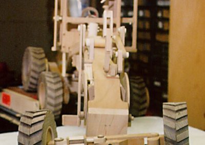 Articulated 3-axel road grader, front view.