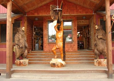 Native American flanked by bears.