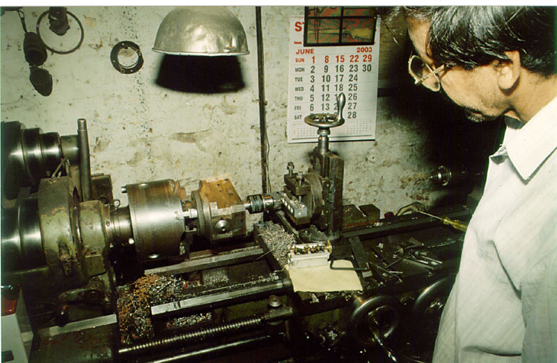 Iqbal at Work Iqbal using a vertical mill table.