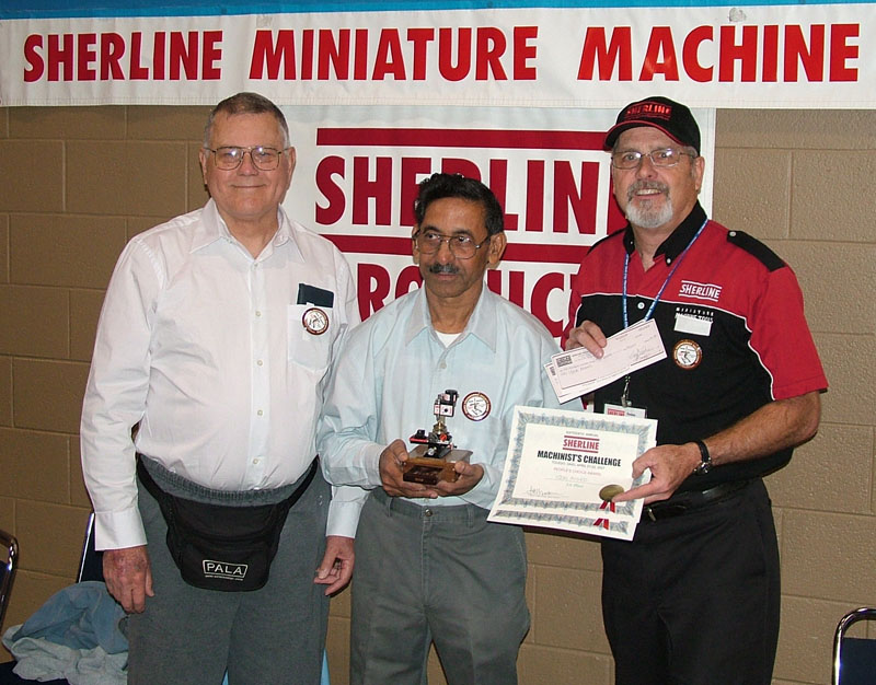 Iqbal Accepts His Award Joe Martin, Iqbal Ahmed, and Craig Libuse.