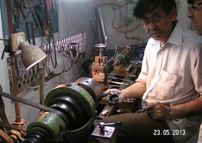 Iqbal working on his large lathe.
