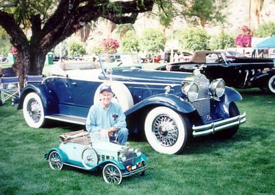 Bill with his roadster in front of a full size version.