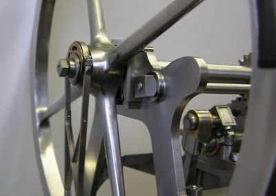 The flywheel for the pumping engine.