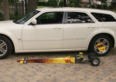 The dragster alongside a full-size car for reference.