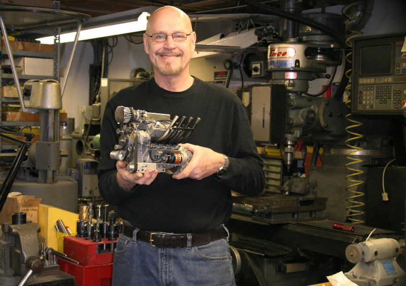 Conley53 Gary holding the new Stinger V-8 while standing in front of his CNC milling machine.