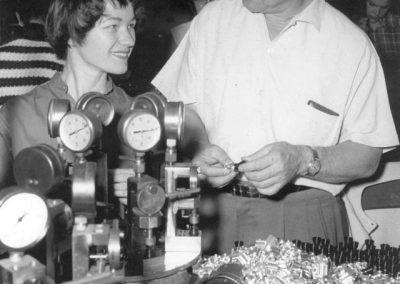 Leroy on the factory floor with a production worker.
