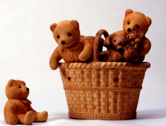 Carved Wooden Teddy Bears Soft, fuzzy looking teddy bears in a wicker basket, all carved from wood by De Marchi.