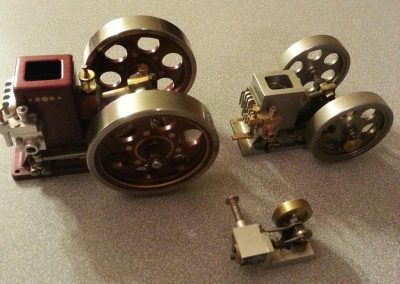 Three miniature hit-n-miss engines.