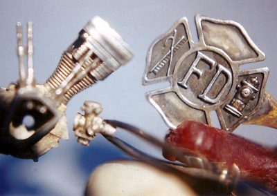 A silver fire department pin made by Bryan.