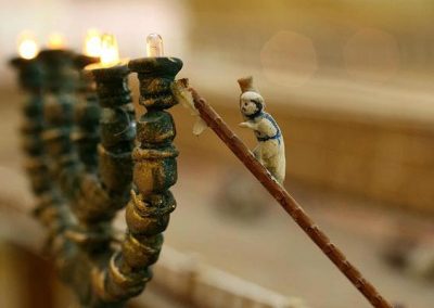 A lamplighter climbing the Menorah.