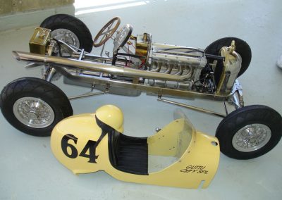 The car with its bodywork removed.