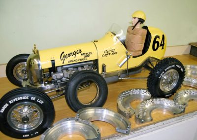 The race car with new knobby tires, and the molds for them.