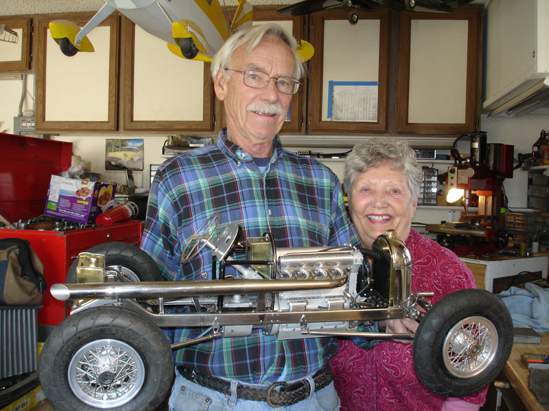 Ron and His Wife in the Shop Ron and his wife with the uncovered scale race car.