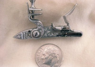 The flintlock mechanism with engraving.