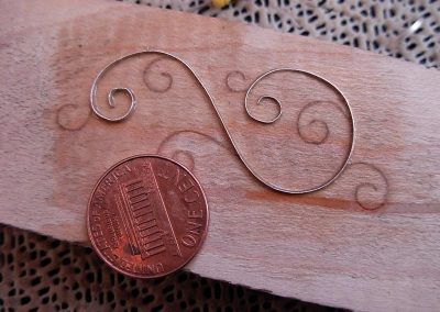 A silver piece formed over a pattern, before it was inlaid.