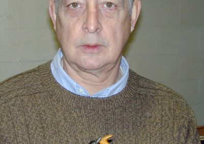 Paul Hamler holding one of his miniature woodworking tools.