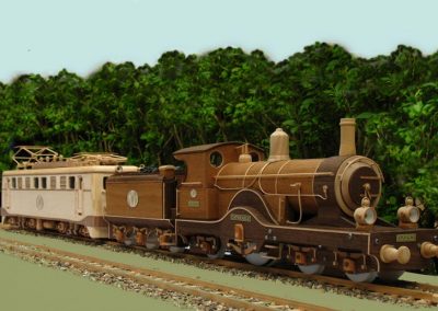 A large steam engine and tender are posed outdoors.