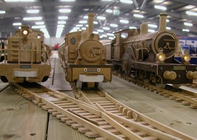 Three engines line the tracks.
