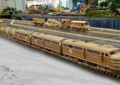 Two engines pulling a string of freight cars.