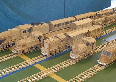 A variety of wooden trains on the tracks.