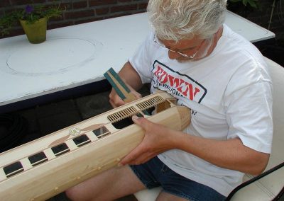 Roberto sanding a passenger car.