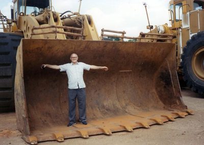Perry standing in the bucket of the full-size front-end loader that he modeled.