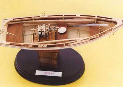 The marine steam engine housed in a wooden launch.