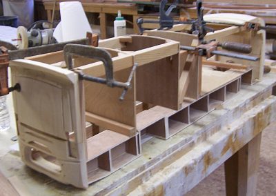 Early construction of a scale model motorhome.
