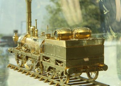 A rear view of the tiny Adler behind glass.