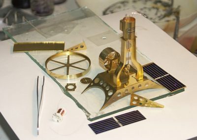 A nearly finished miniature brass steam engine.