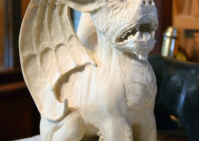 A carved wooden gargoyle.