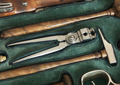 A miniature bullet mould and hammer to go along with the Boutet pistols.