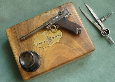 Michel's miniature Navy Luger sits on its case.