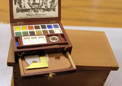 A miniature painter’s toolbox.
