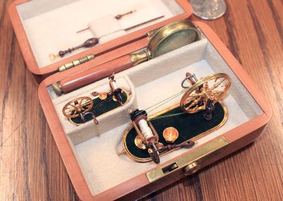 The tiny spinning wheels are packed in their wooden case.