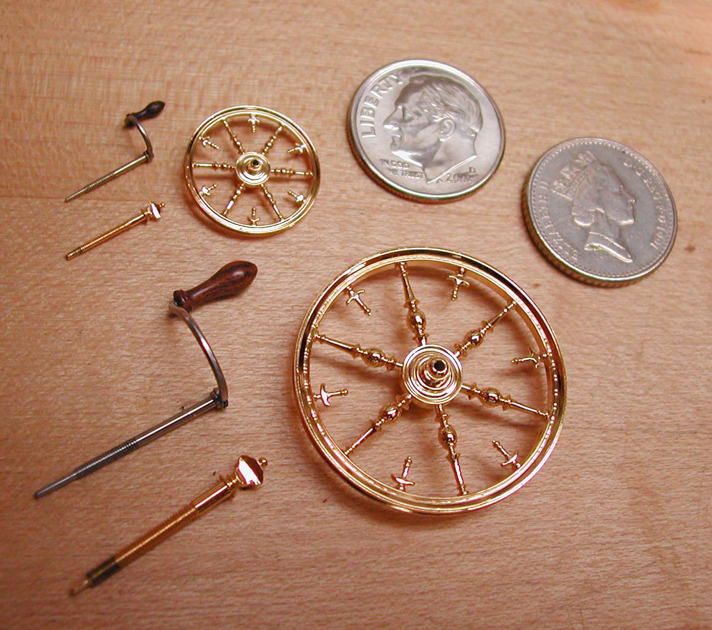 French Spinning Wheel Components A dime provides scale reference for these tiny spinning wheels.