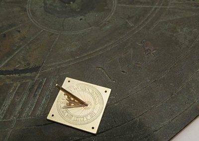 A tiny brass sundial.