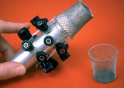 A miniature metal wire mesh waste basket.