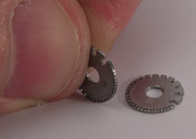Bill’s thumb dwarves these miniature tools.
