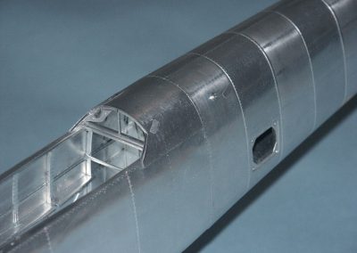 The basic fuselage structure takes shape in aluminum.
