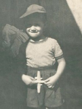 Guillermo as a child. A young Guillermo holding a small model plane.