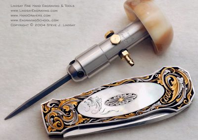 One of Steve’s custom AirGravers sits next to a custom engraved knife.