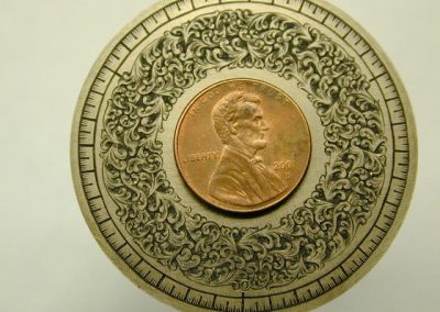 This photo of the dial highlights the fine details of Roger’s engraving.